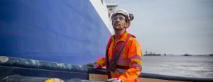 Shell employee in orange safety gear working on-site-1440x560px